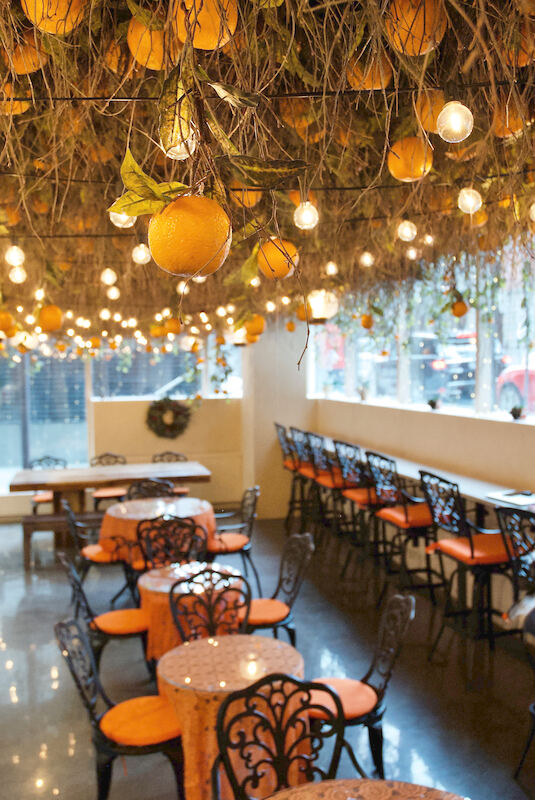 picture of solit cafe with oranges hanging from ceiling